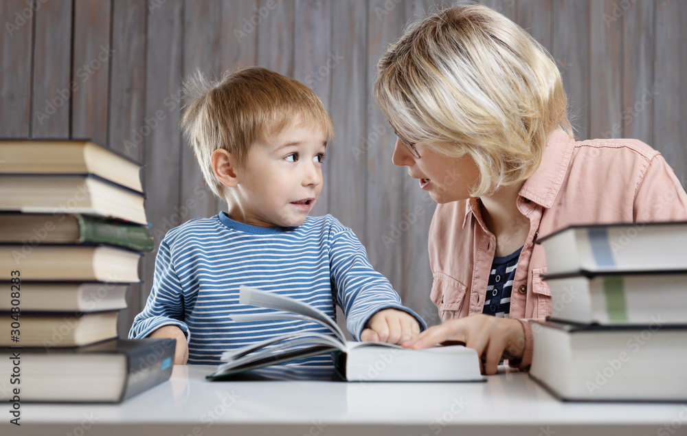 five years old child reading a book at home with mother five years old child reading a book at home with mother