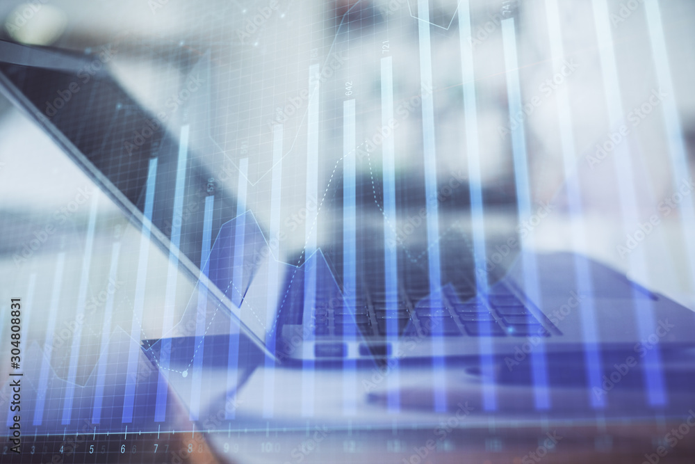 Forex graph hologram on table with computer background. Double exposure. Concept of financial markets. Forex graph hologram on table with computer background. Double exposure. Concept of financial markets.