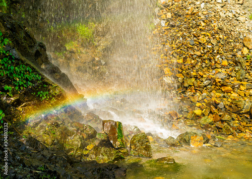 Fototapeta Naklejka Na Ścianę i Meble -  A perennial roadside waterfall and a rainbow, Mussoorie, Uttarakhand, India
