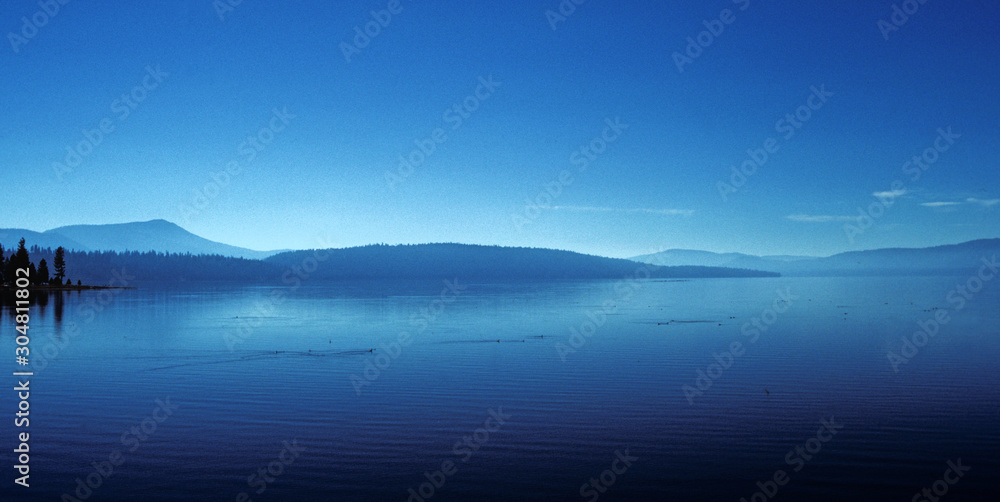 Tranquil Lake, blue sky, blue water. rolling hills