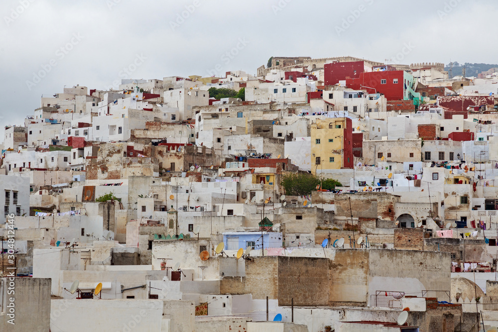 View of the colorful old buildings of Tetouan Medina quarter in Northern Morocco. A medina is typically walled, with many narrow and maze-like streets and often contain historical houses and places.