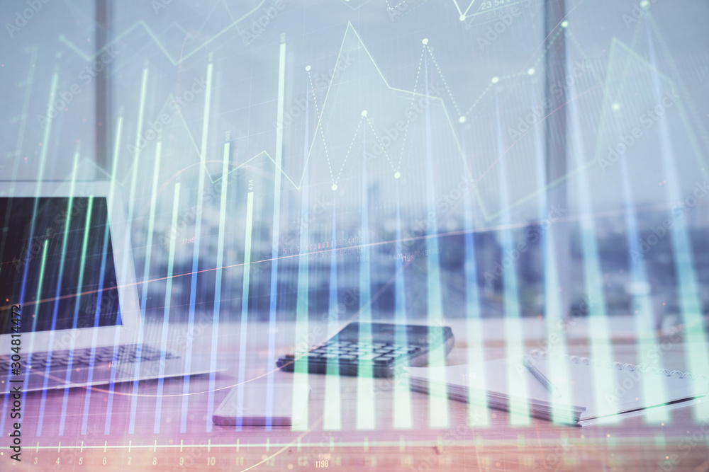 Forex graph hologram on table with computer background. Multi exposure. Concept of financial markets. Forex graph hologram on table with computer background. Multi exposure. Concept of financial markets.