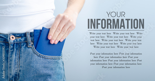 Woman put passport in pocket jeans on gray light background, space for text