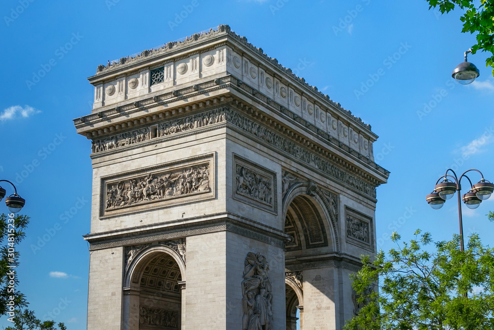 View of the famous Triumphal Arch in Paris, France. The Arc de Triomphe honours those who fought and died for France in the French Revolutionary and Napoleonic Wars.