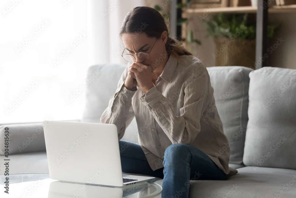 Pensive woman look at laptop thinking of problem solution Pensive woman look at laptop thinking of problem solution