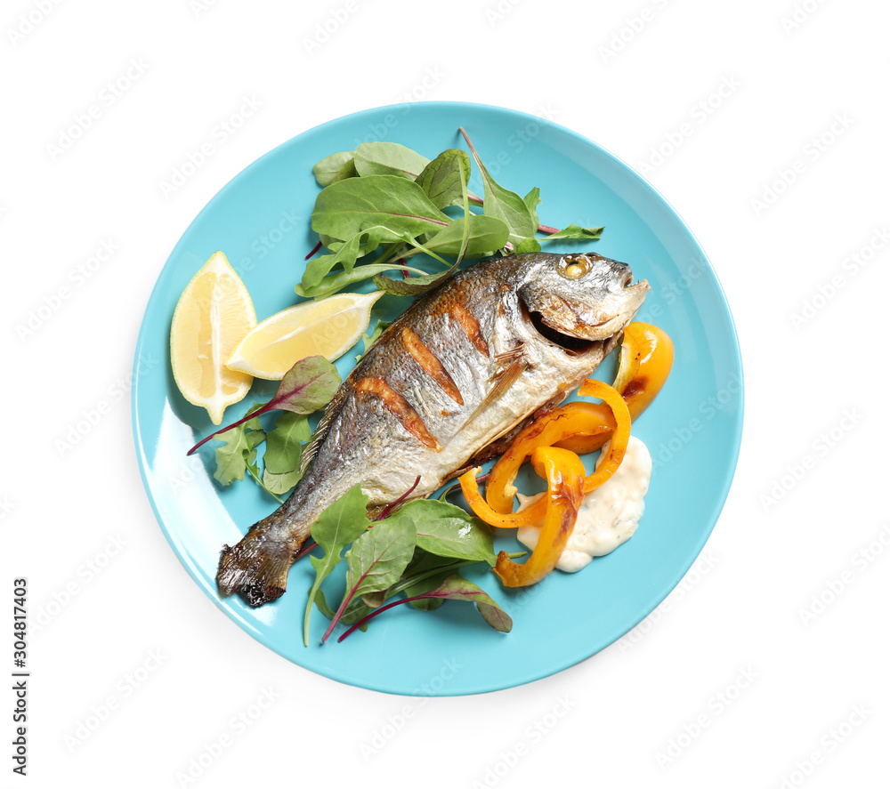Delicious roasted fish with lemon and vegetables isolated on white, top view Delicious roasted fish with lemon and vegetables isolated on white, top view
