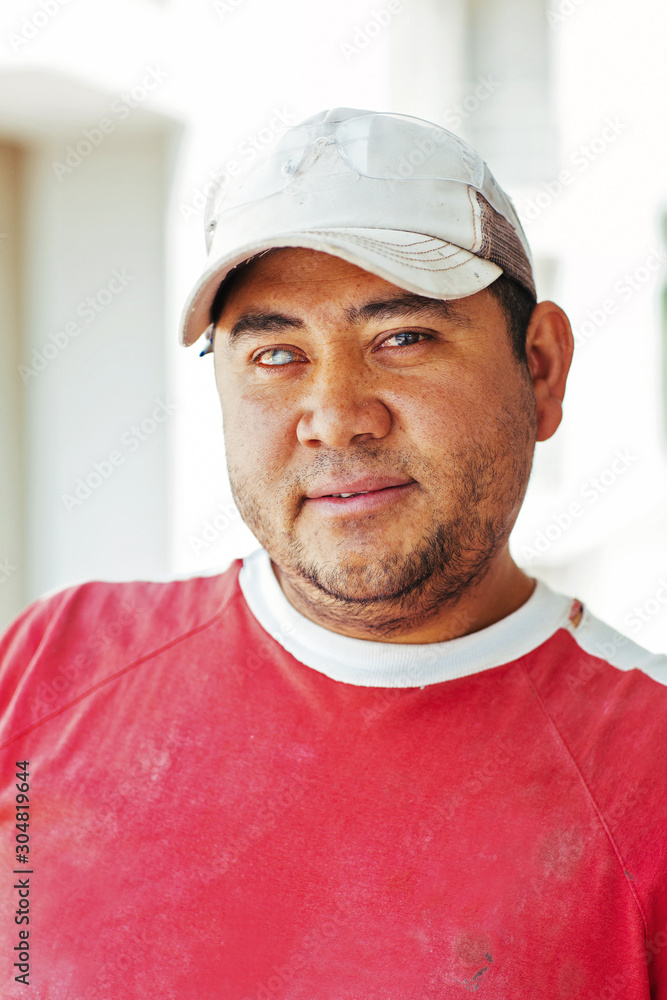 Close up of bricklayer wearing baseball cap Close up of bricklayer wearing baseball cap