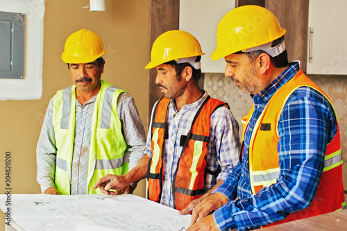 Construction team looking at blueprint