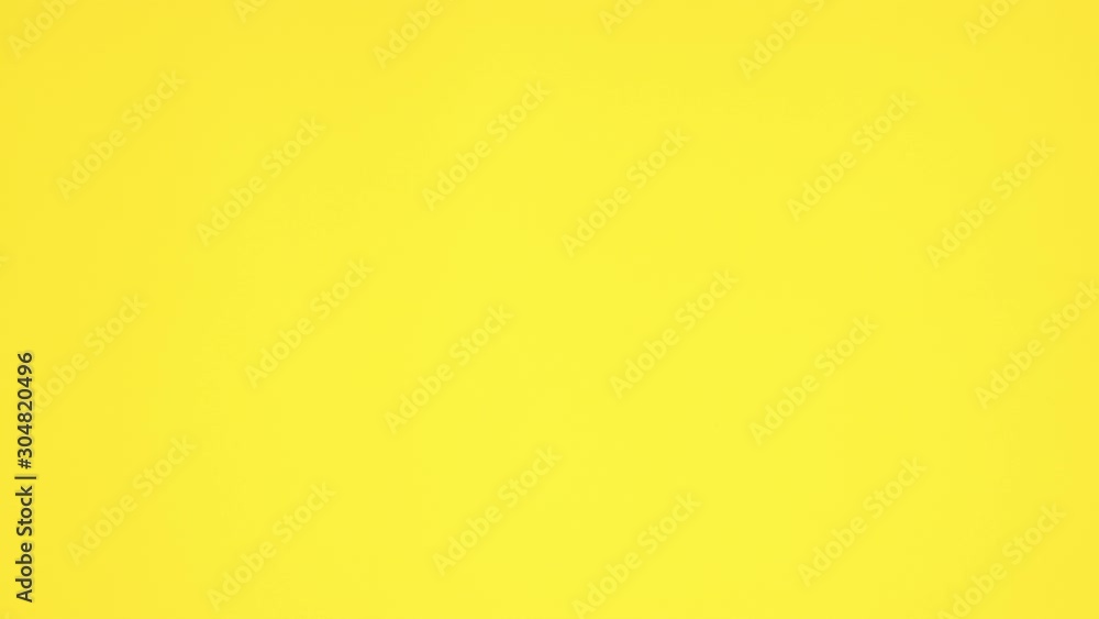 Stop motion animation of colorful buttons on yellow background Stop motion animation of colorful buttons on yellow background