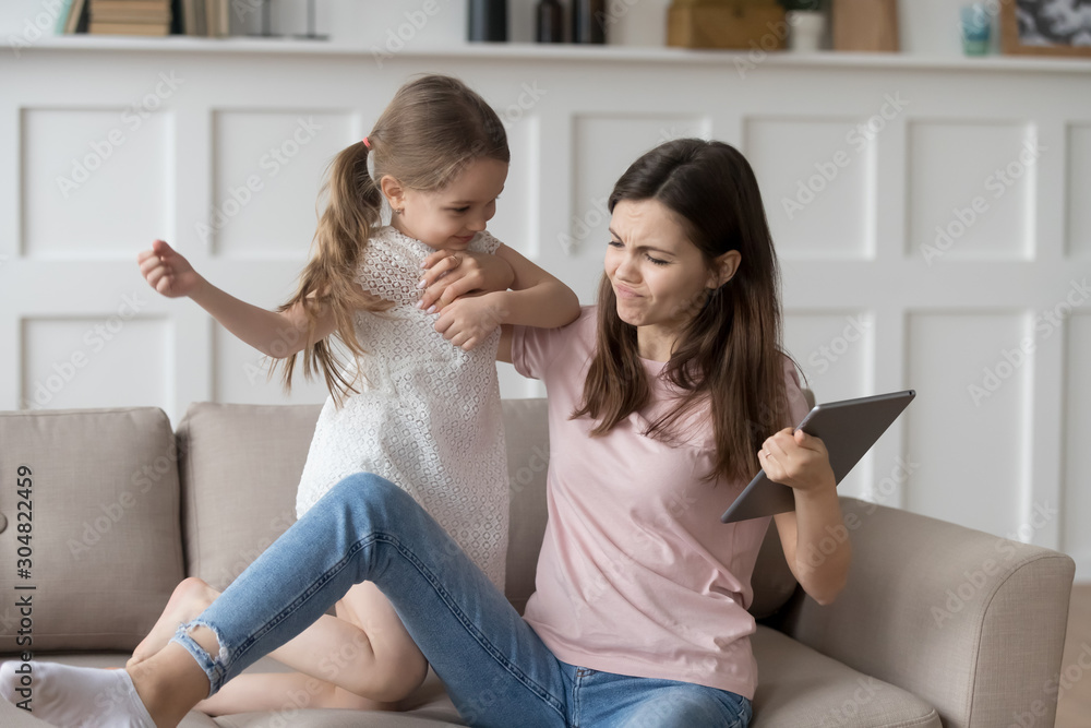 Preschooler girl demand tablet fighting with young mom Preschooler girl demand tablet fighting with young mom