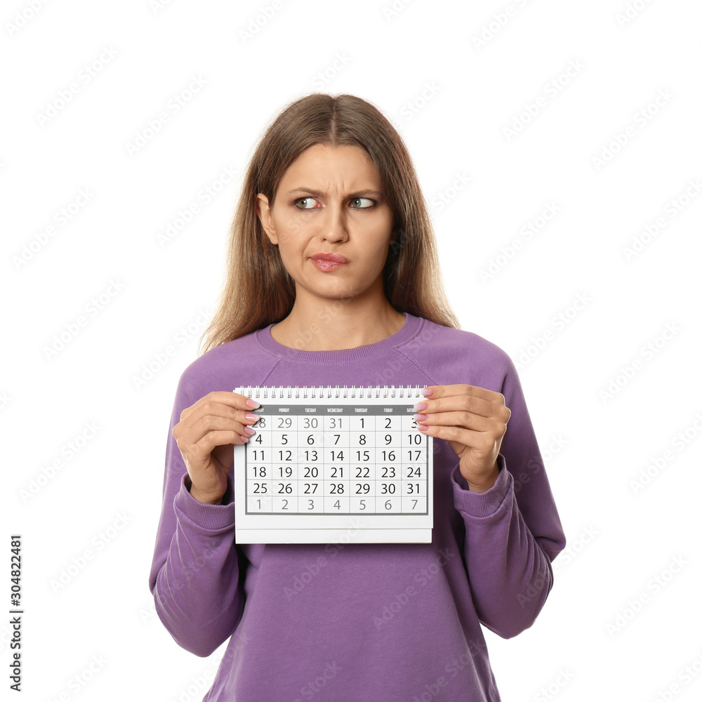 Emotional young woman holding calendar with marked menstrual cycle days on white background Emotional young woman holding calendar with marked menstrual cycle days on white background