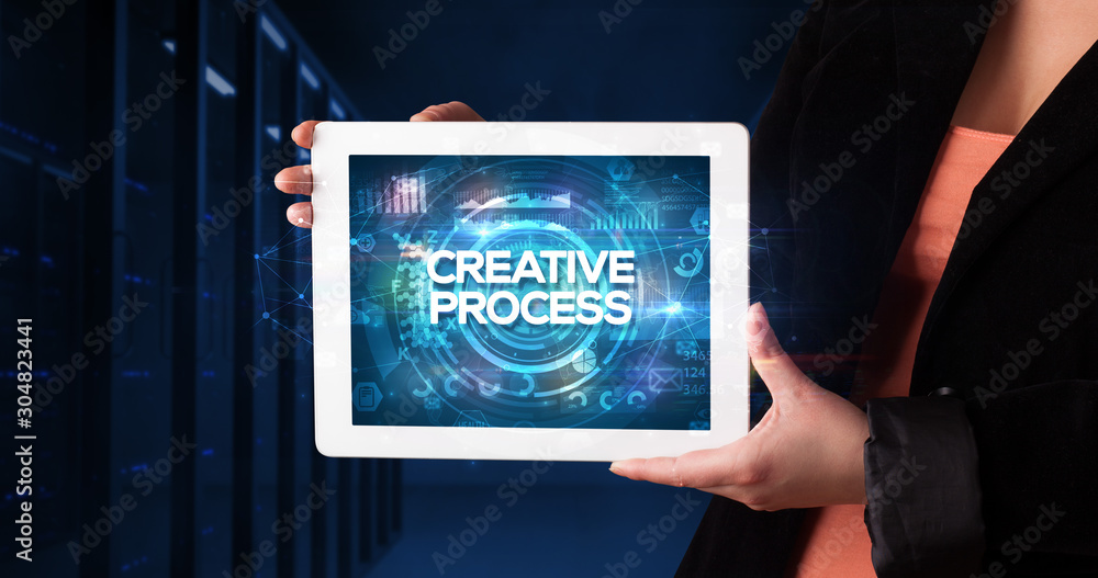 Young business person working on tablet and shows the inscription: CREATIVE PROCESS, business concept Young business person working on tablet and shows the inscription: CREATIVE PROCESS, business concept