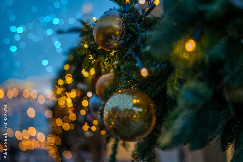 Festive street decor in winter holidays. Shining garland lights. Magical atmosphere. Blurred background city street with Christmas illuminations. Festive street decor in winter holidays. Shining garland lights. Magical atmosphere. Blurred background city street with Christmas illuminations.