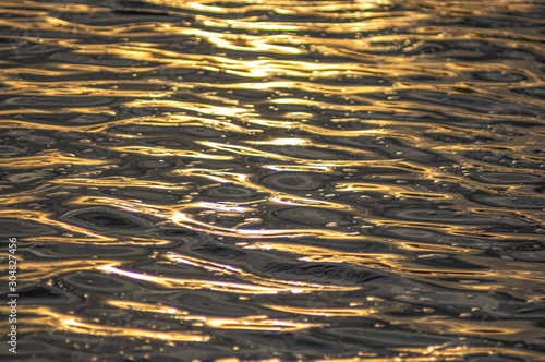 Waves at sunset on the river water
