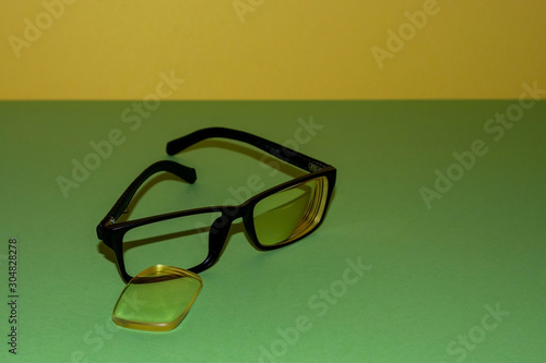 Broken glasses lie on a green surface