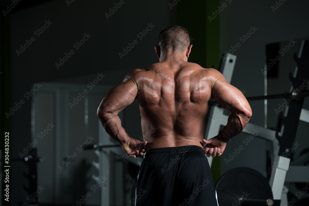 Mature Muscular Man Flexing Muscles In Gym Mature Muscular Man Flexing Muscles In Gym