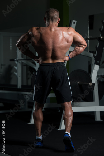 Mature Bodybuilder Posing Biceps After Exercises
