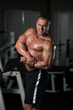 Mature Bodybuilder Posing Biceps After Exercises