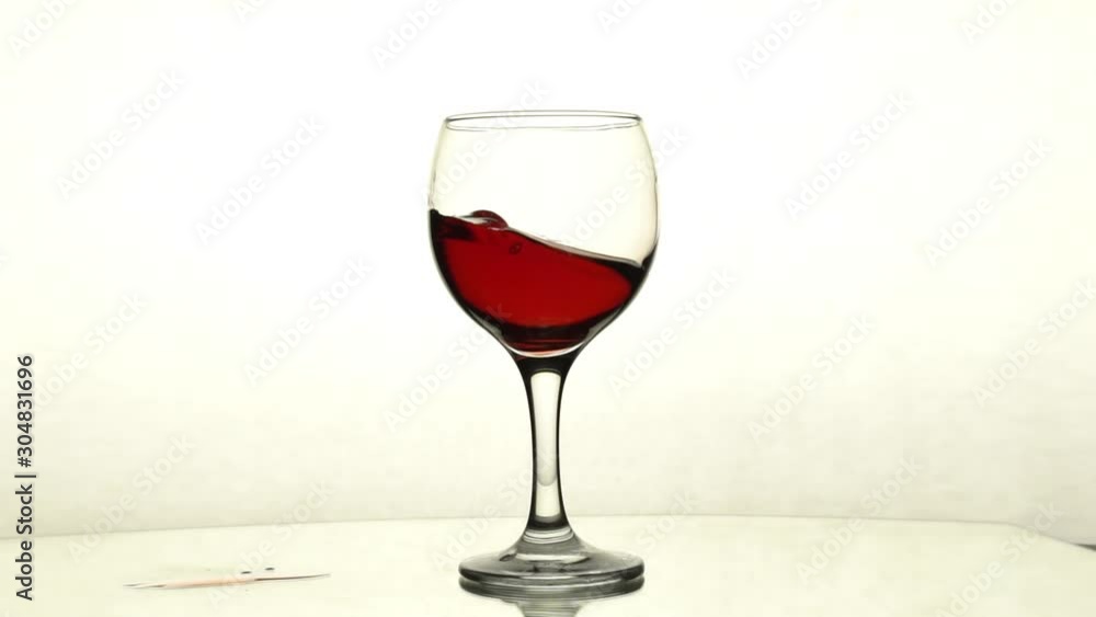 Red wine splashes in the glass Red wine splashes in the glass