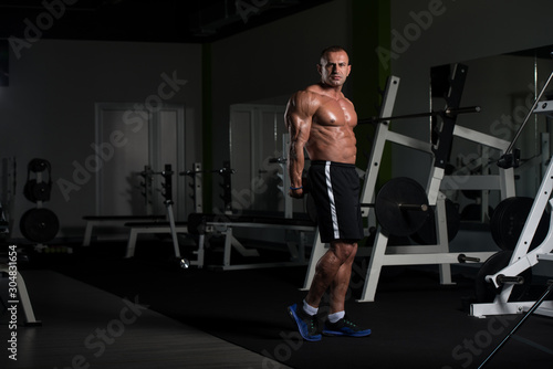 Mature Muscular Man Flexing Muscles In Gym
