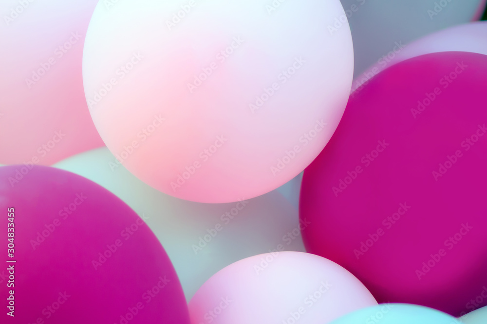 colored balloons. light, pink, purple. nice soft colors. decorative wall as background