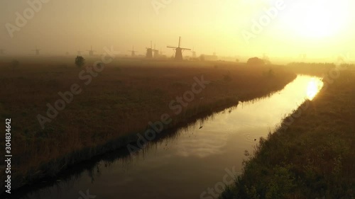 Aerial drone view of beautiful classic Dutch landscape of windmills and meadow during sunrise at Kinderdijk, a landmark destination in the Netherlands Holland