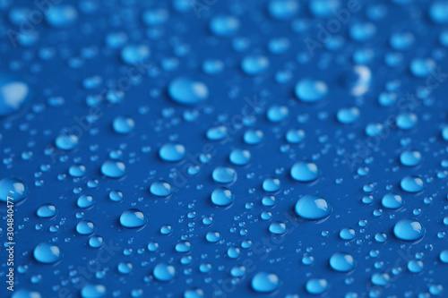 Water drops on blue background, closeup view