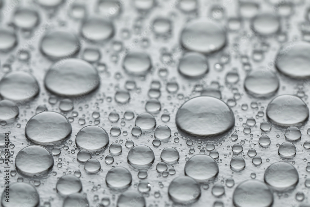 Water drops on grey background, closeup view Water drops on grey background, closeup view
