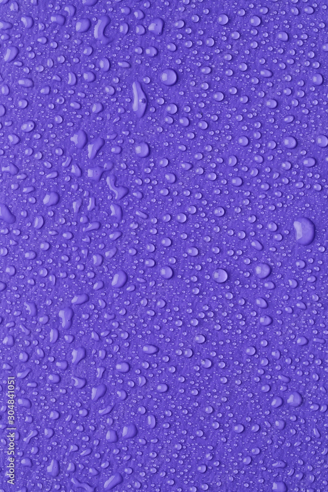 Water drops on lilac background, top view Water drops on lilac background, top view