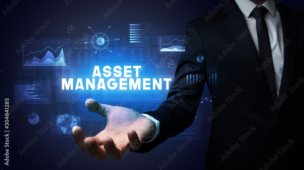 Hand of Businessman holding ASSET MANAGEMENT inscription, business success concept Hand of Businessman holding ASSET MANAGEMENT inscription, business success concept