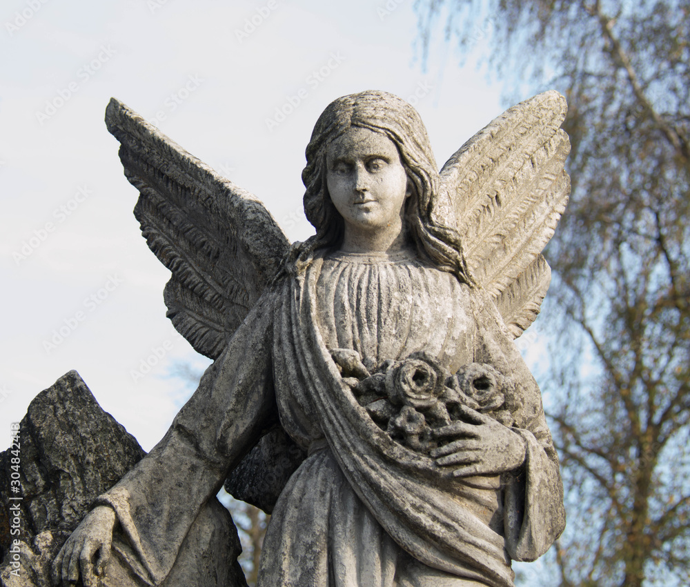 Monument and candles in the cemetery. All Saints Day in Poland.