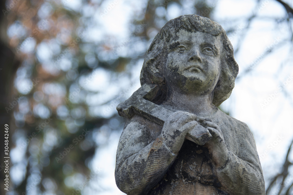 Monument and candles in the cemetery. All Saints Day in Poland.