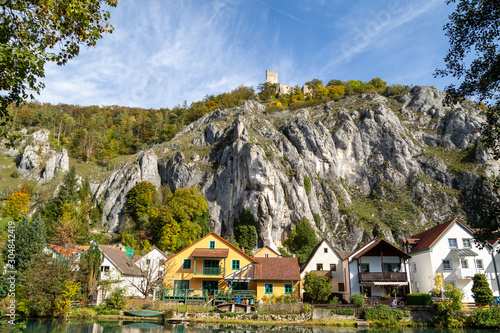 Idyllic view at the village Markt Essing in Bavaria, Germany with the Altmuehl river and high rocks photo