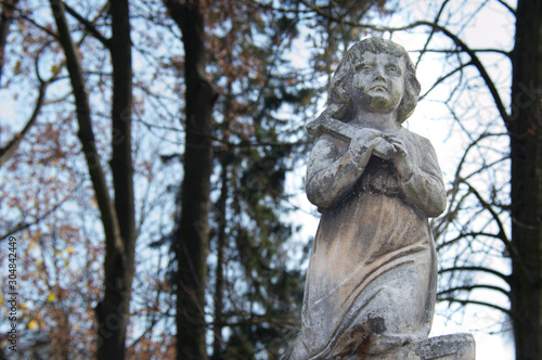 Monument and candles in the cemetery. All Saints Day in Poland.