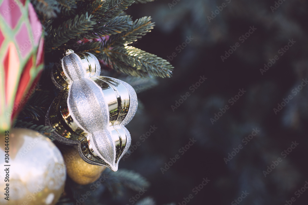 Christmas toys on the branches of the Christmas tree, close up