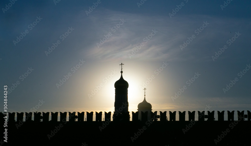 Moscow Orthodox Cathedral on the background of the Kremlin wall on Red Square during sunset