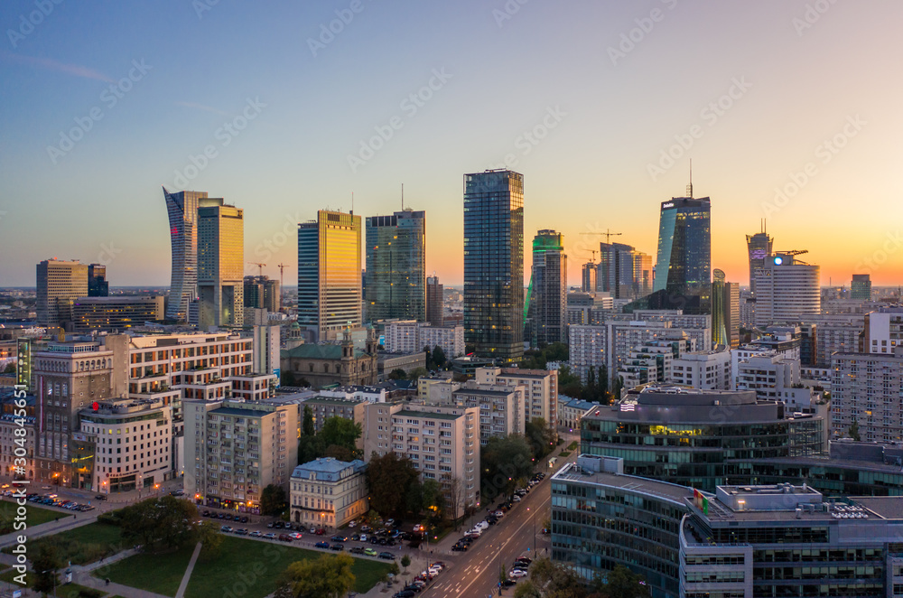 Drone shot at skyscrapers and buildings at dusk at sunset in Warsaw. Poland. 19. October.  2019. Aerial view of the city of Warsaw, skyscrapers and buildings, evening autumn evening sunset.