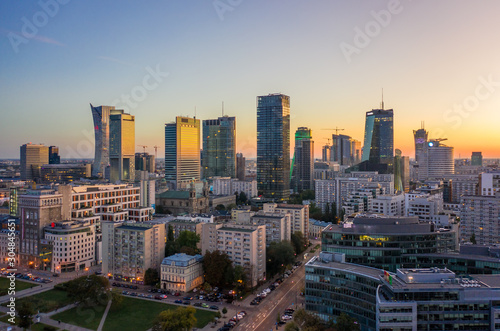 Drone shot at skyscrapers and buildings at dusk at sunset in Warsaw. Poland. 19. October. 2019. Aerial view of the city of Warsaw, skyscrapers and buildings, evening autumn evening sunset.