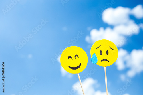 KYIV, UKRAINE - MAY 25, 2019: paper cut disappointed but relieved and smiling emoji