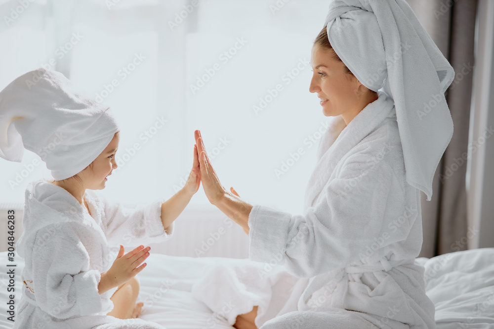 attractive beautiful female clap hands with each other, wearing bathrobe and towel, white bedroom background, white bed attractive beautiful female clap hands with each other, wearing bathrobe and towel, white bedroom background, white bed