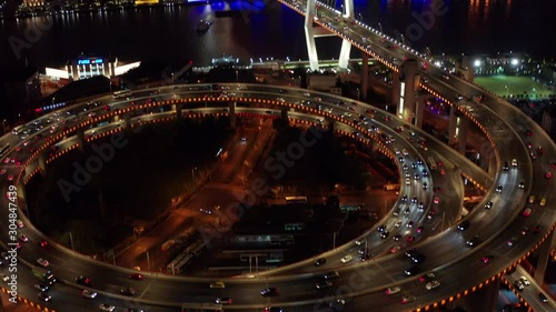 Aerial drone 4k video scene of traffic on Nanpu Spiral road at night, Nanpu bridge, Huangpu River,  Shanghai, China
