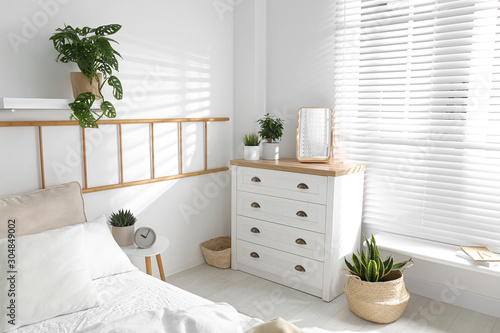 Fototapeta Naklejka Na Ścianę i Meble -  White chest of drawers in beautiful bedroom. Interior design