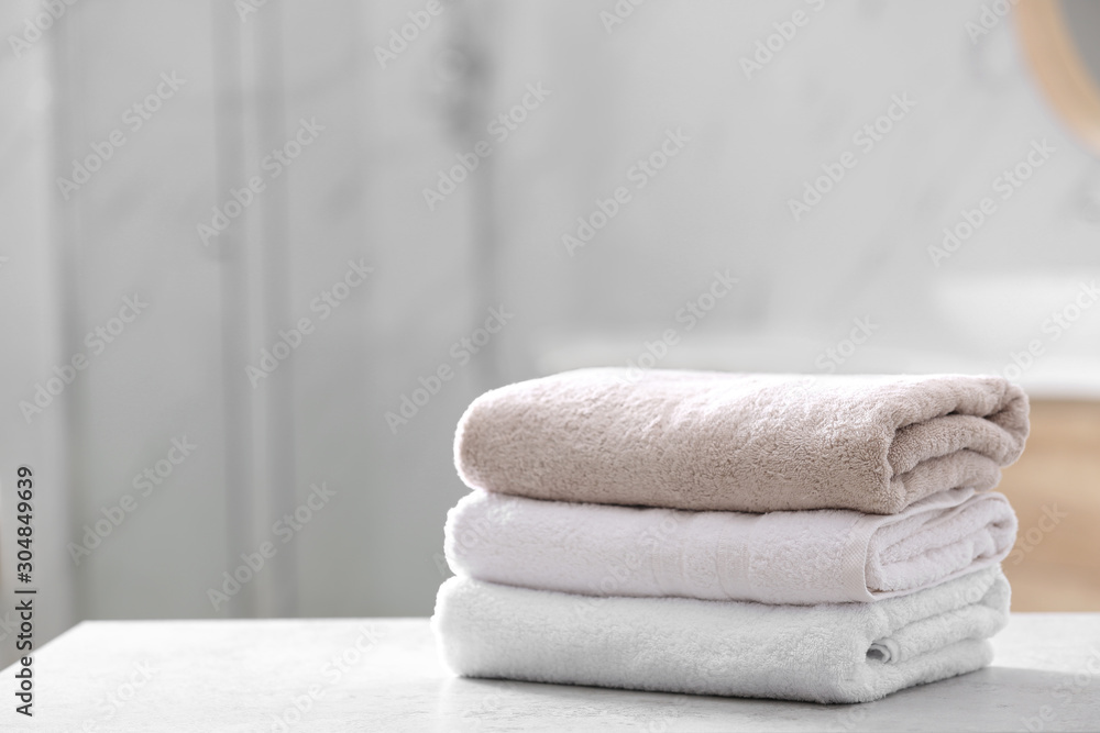 Stack of clean towels on table in bathroom Stack of clean towels on table in bathroom