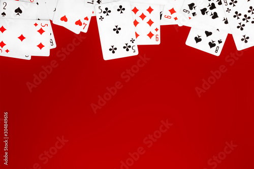 Deck of playing cards on red background table copy space photo