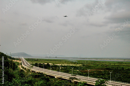 Airplane over highway to Brazzaville in Congo. Aerial panoramic view.