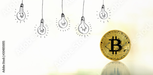 Idea light bulbs with gold bitcoin cryptocurrency coin