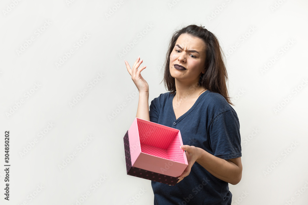Portrait of a happy smiling girl opening a gift box isolated over white background Portrait of a happy smiling girl opening a gift box isolated over white background