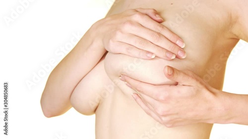 Woman having a breast pain and massaging her chest. Mastalgia concept. photo