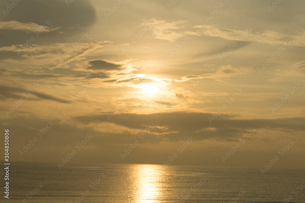 Beautiful dawn, morning sun rises by the sea. Scenic beach, coastline, rocks, cloudscape and skyline photography. Sunrise during the early hours of a summer morning by the beach. Sunset by the beach.