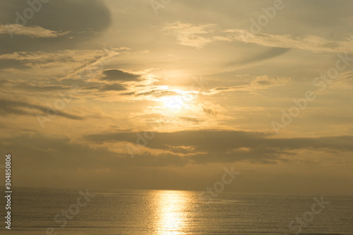 Beautiful dawn, morning sun rises by the sea. Scenic beach, coastline, rocks, cloudscape and skyline photography. Sunrise during the early hours of a summer morning by the beach. Sunset by the beach. © Atthapon